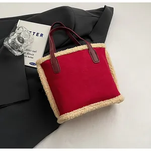 Close-up of red suede bucket bag with beige faux fur trim and premium leather handles