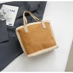 Close-up of warm brown faux suede tote bag with cream-colored faux shearling trim details