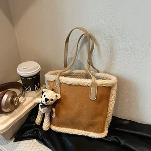Brown suede tote bag with white faux shearling trim and cute bear charm for autumn