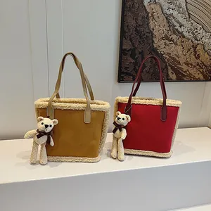 Fleece-trimmed suede tote bags in ginger and burgundy with cute bear pendants