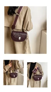 Detail of burgundy saddle bag with leopard texture and wide CLASSIC strap
