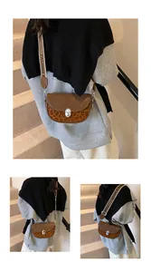 Detail of leopard print saddle bag with wide strap and silver metallic lock buckle