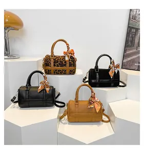 Group of Boston barrel bags in leopard print, black and tan with decorative scarves