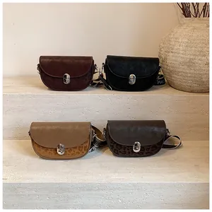 Detail view of retro saddle bags with leopard print accents and wide canvas straps