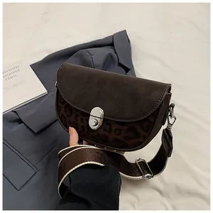 Detail of vintage leopard print saddle bag with suede flap and silver twist lock
