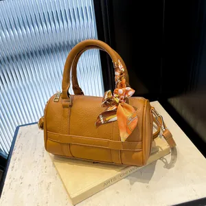 Classic camel textured Boston bag with decorative silk scarf and adjustable strap