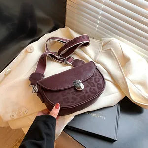 Vintage leopard print saddle bag in burgundy with a classic wide woven strap