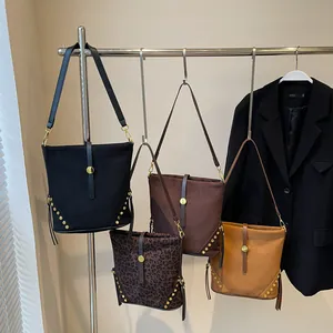 Street style suede bucket bags in assorted colors with metal rivets and leopard print