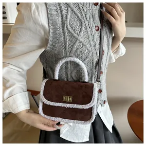 Detail of vintage brown suede mini square bag with white faux fur trim and gold lock