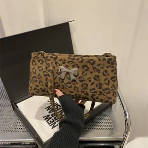 Fashionable leopard print shoulder bag with a silver bow accent for elegant style