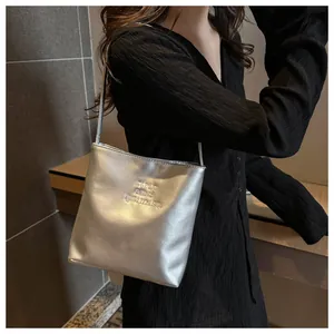 Detail of silver metallic bucket bag with study and optimism embroidery on soft leather