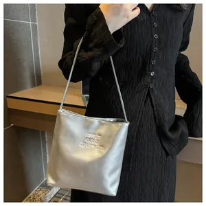 Detail view of stylish silver metallic shoulder bag with sixty and ipumian embroidery