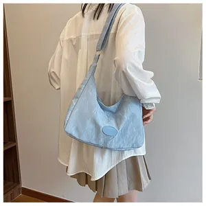Detailed view of light blue hobo bag with pleated texture and stylish shoulder strap