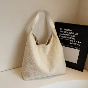 Tragetasche aus cremeweißem Plüsch mit weißen Lederriemen für minimalistische Herbstmode