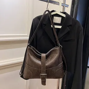 Retro dark brown half-moon tote bag with decorative buckle and slim shoulder strap
