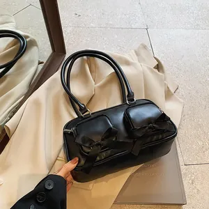 Elegant black bow shoulder bag with double zipper pockets and chic ballet style aesthetic