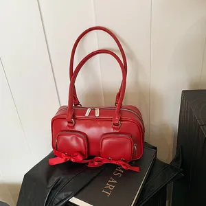 Red matte leather Boston shoulder bag with dual bow front pockets and silver hardware