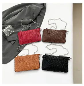 Flat lay of four textured woven chain bags in red, brown, khaki, and black colors