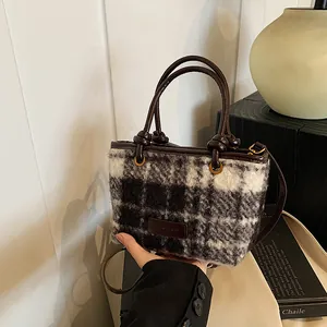 Minimalist wool plaid tote bag with leather handles and adjustable shoulder strap