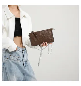 Close-up of dark brown woven texture handbag with silver beaded edge and chain strap