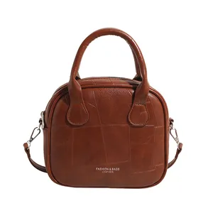 Vintage karamellbraune Leder-Henkeltasche mit geometrischem Patchwork und Riemen
