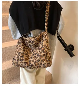 Detail of plush leopard print tote bag texture and wide strap on model shoulder