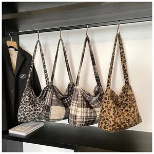 Furry tote bags with leopard print and plaid patterns shown on a fashion display rack