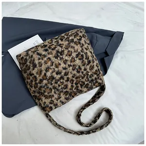 Detailed view of the fuzzy leopard print texture on the plush tote bag surface
