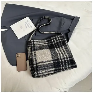 Detail shot of the large black and white checkered fuzzy tote bag with thick wool texture