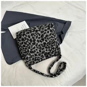 Close-up of plush leopard print tote bag with soft texture and integrated shoulder strap
