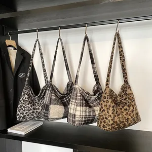 Winter faux fur large tote bags in leopard print and plaid patterns shown on hangers