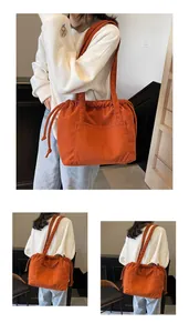 Detail of orange corduroy tote bag showing ribbed texture and drawstring closure