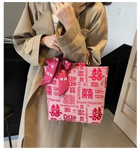 Close-up of pink canvas wedding tote with Double Happiness print and bamboo handle
