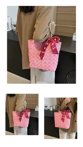 Detail of pink bridal tote bag with bamboo handle and traditional Chinese double happiness motif