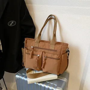 Large brown nylon tote bag with multi-pocket design for business travel and daily commuting
