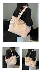 Detail of pink quilted tote bag with multi-pocket design and wide shoulder strap