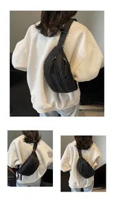 Detail view of black quilted nylon chest bag with adjustable strap and diamond stitching