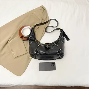 Retro black leather hobo bag with vintage gold rivets and adjustable shoulder strap