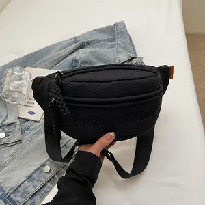 Black quilted nylon chest bag with letter embroidery and adjustable shoulder strap