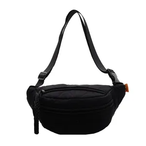 Black quilted nylon crossbody chest bag with diamond patterns and adjustable strap