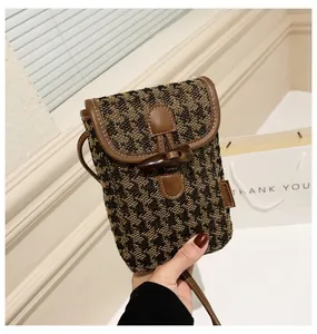 Fashion houndstooth crossbody phone bag with brown leather trim and horn buckle detail