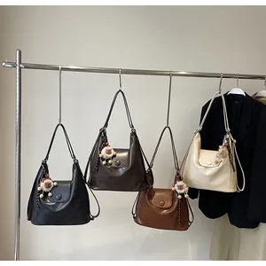 Detailed display of tote bags in four colors with lion plush charms and metal buckles