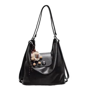 Black large-capacity hobo tote bag with soft matte leather and plush doll pendant detail