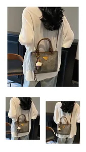 Detail of vintage grey tote bag with twisted handle and ice cream charm accessory