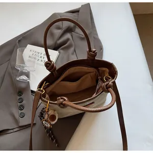 Macro view of canvas tote bag interior with zipper pocket and brown leather handles