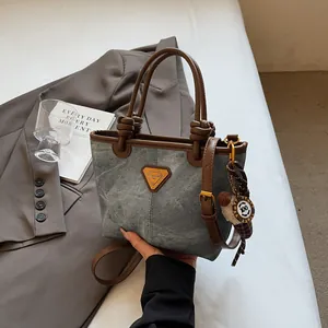 Retro grey denim basket tote bag with brown leather handles and adjustable shoulder strap