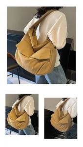 Detail of khaki canvas crossbody bag with large front pockets and wide shoulder strap