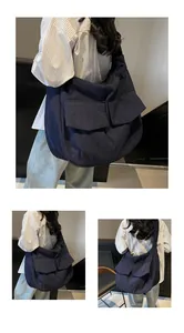 Detail of navy blue large capacity canvas bag with front pockets on shoulder
