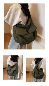 Detail of large nylon messenger bag in olive green with functional flap pockets