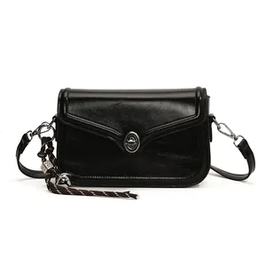 Glossy black vintage crossbody square bag with silver clasp and decorative charm pendant